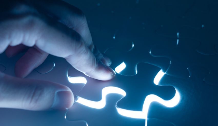 A person is putting a piece of jigsaw puzzle together.