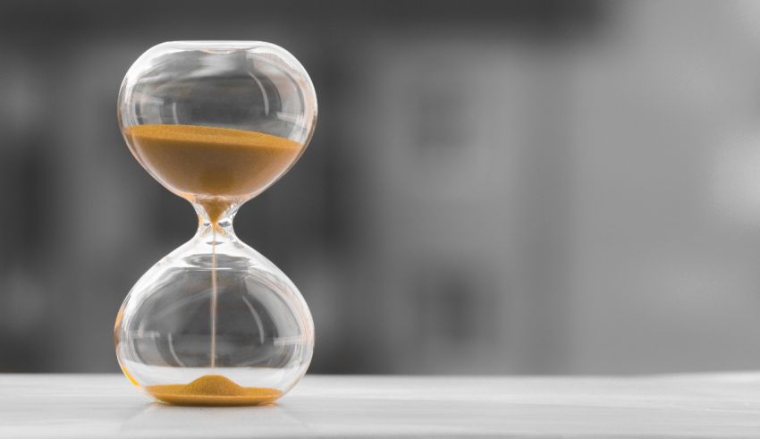 A sand hourglass sitting on a table.