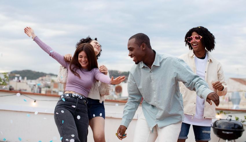 A group of friends dancing on a rooftop.