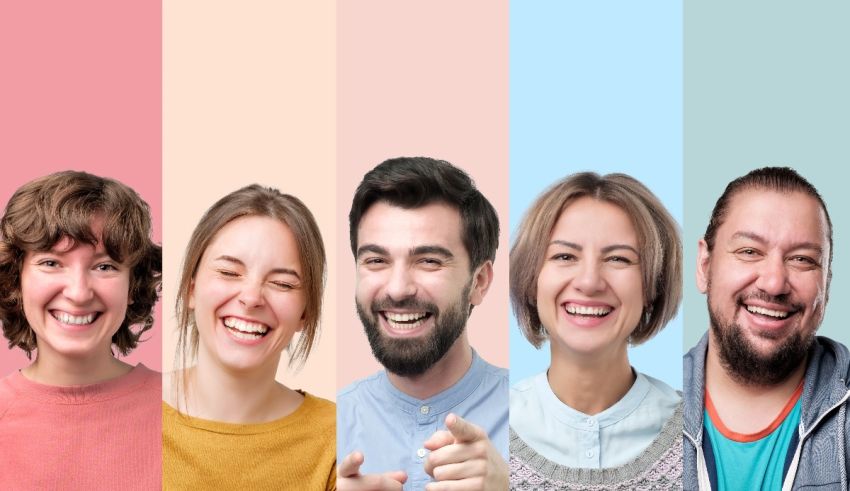 A group of people smiling in front of a colorful background.