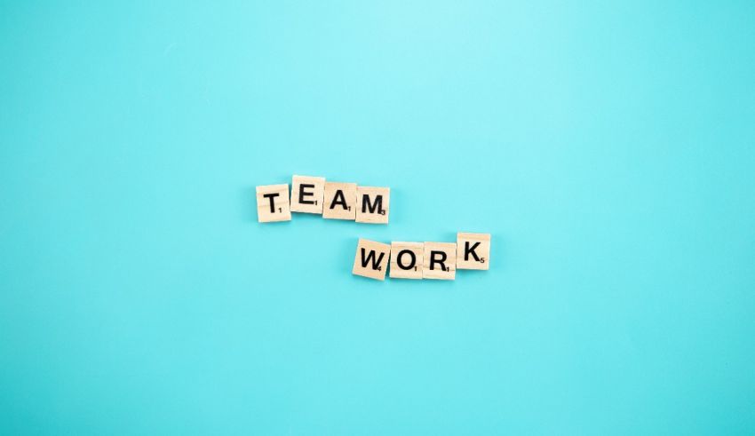 The word team work spelled out on a blue background.