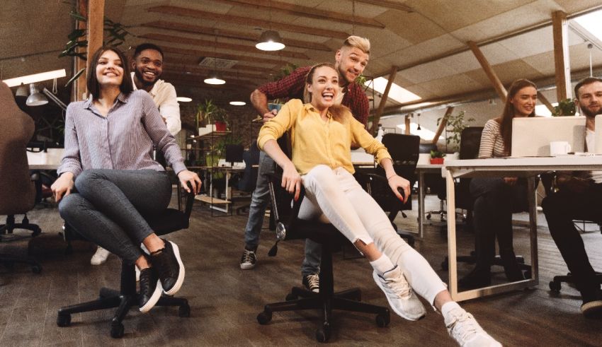A group of people sitting on chairs in an office.