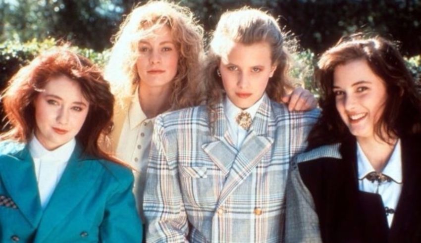 A group of women in suits posing for a picture.