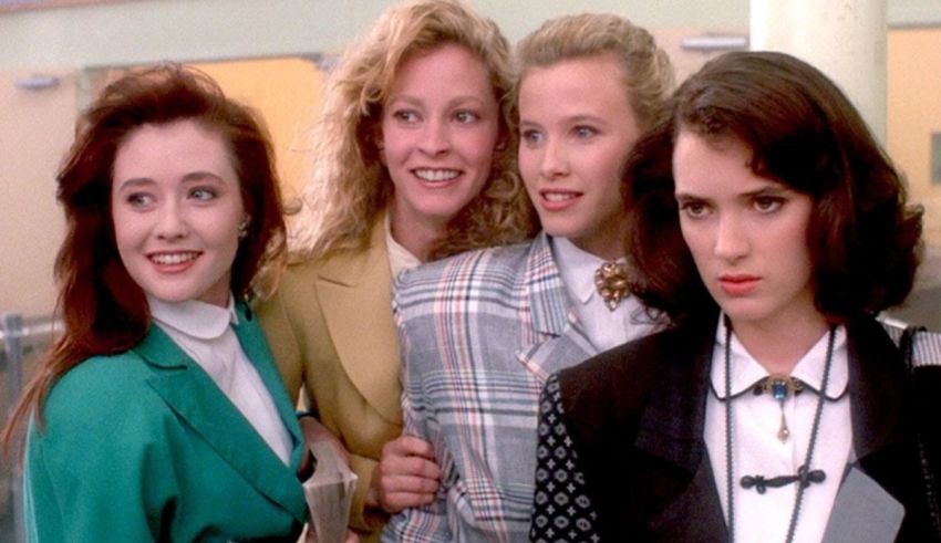 A group of women posing for a picture in a hallway.