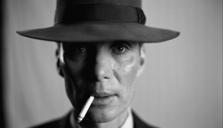 A man in a hat smoking a cigarette.
