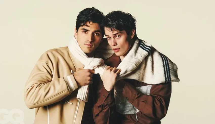 Two men posing for a photo in a white background.