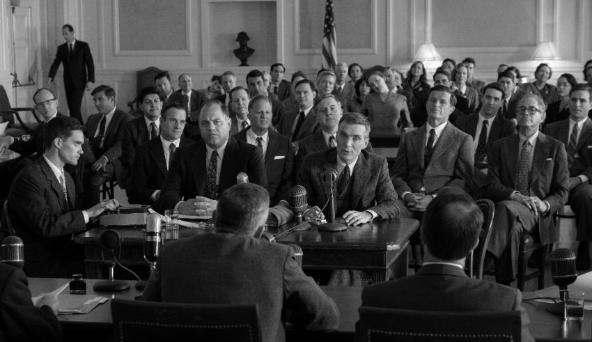 A black and white photo of a group of people sitting at a table.