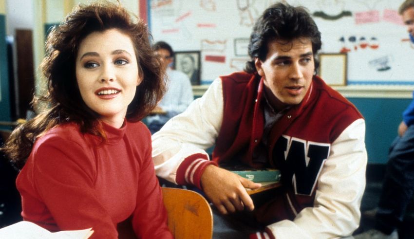 A man and a woman sitting in a classroom.