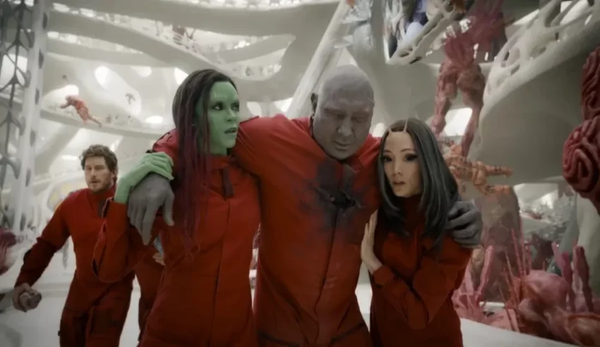 A group of people in red suits standing next to each other.