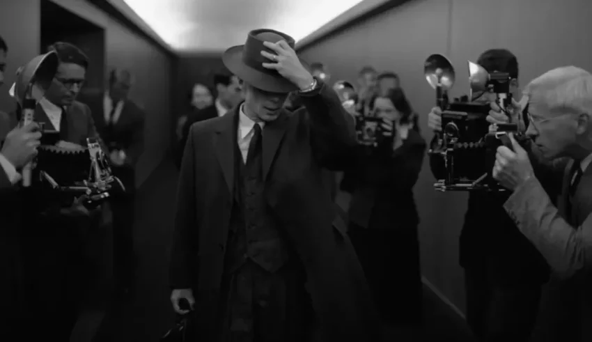 A man in a suit walking down a hallway.