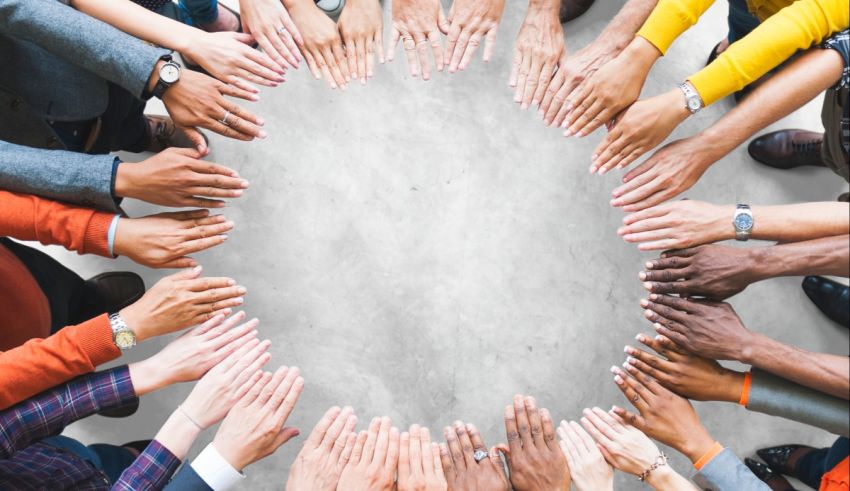 A group of people holding hands in a circle.