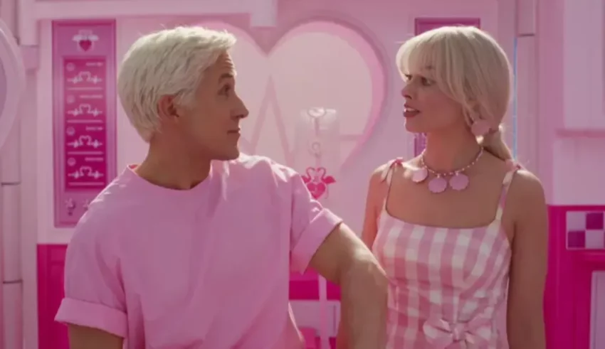 A man and a woman standing in a pink room.