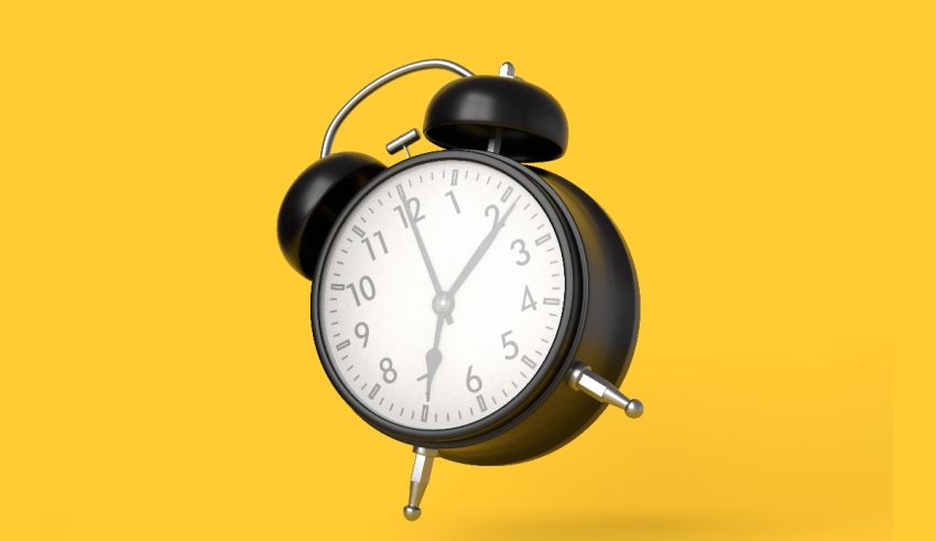 A black alarm clock on a yellow background.