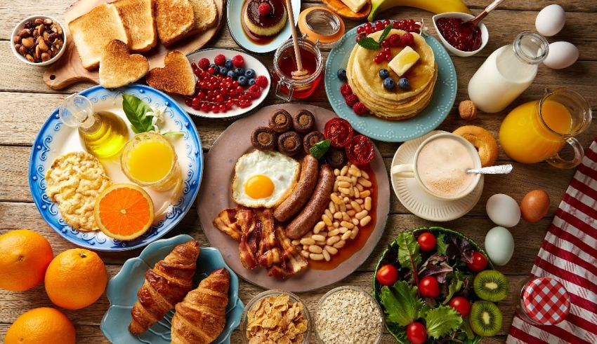 A variety of breakfast foods are arranged on a table.