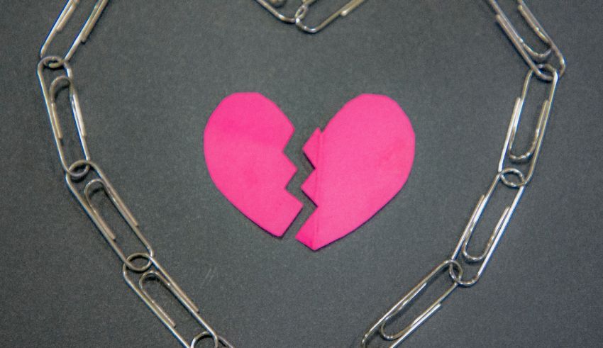 Broken heart on a chain stock photo.