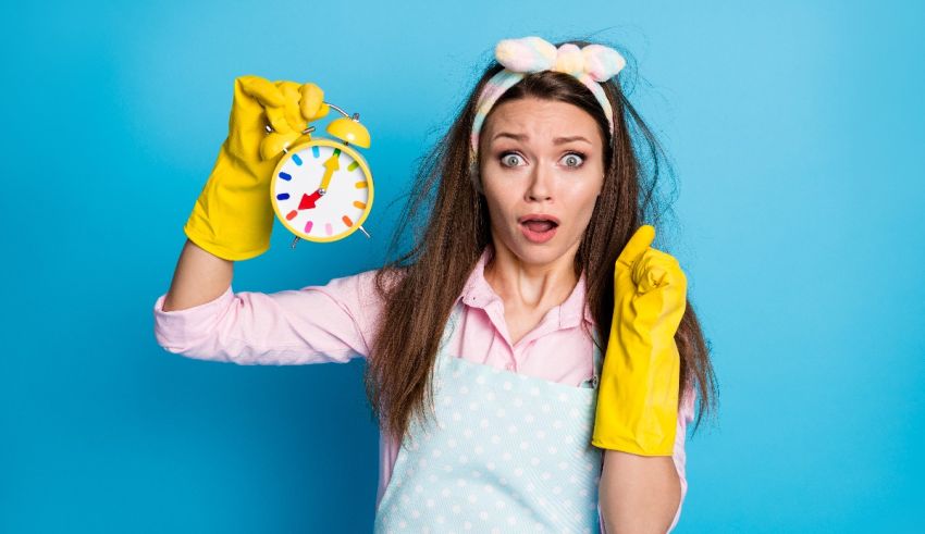 A woman in yellow gloves holding a clock on a blue background.