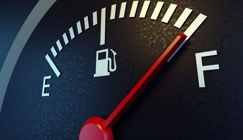 A close up of a fuel gauge on a black background.