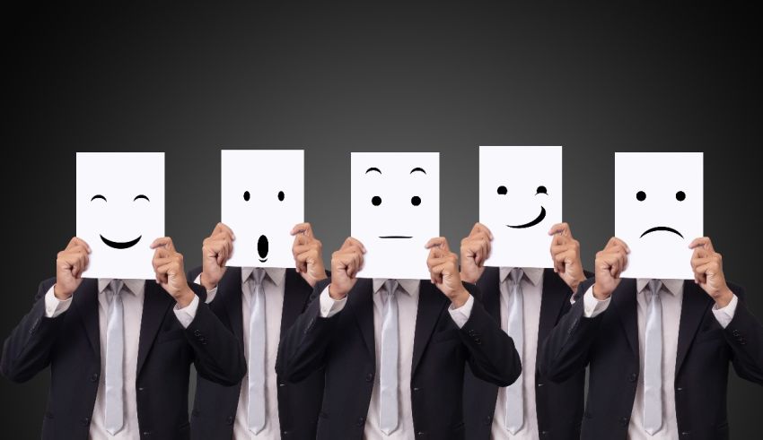 A group of businessmen holding paper with smiley faces on it.