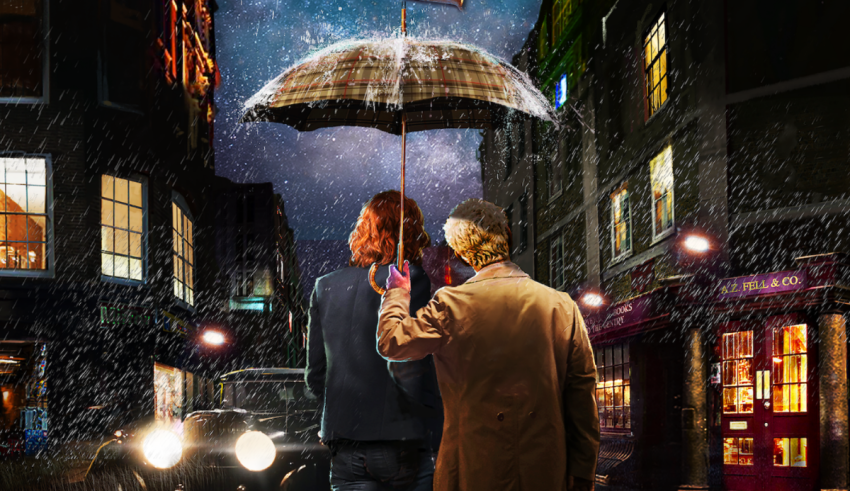 Two people standing under an umbrella in the rain.