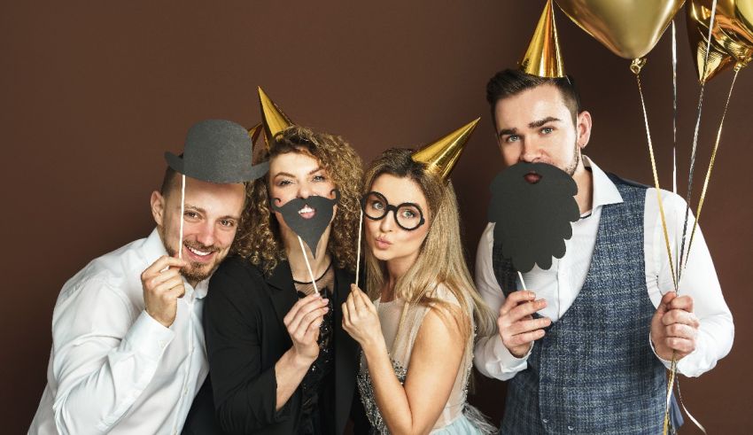 A group of people posing for a photo with fake beards and balloons.