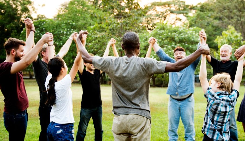 A group of people holding hands in the park.