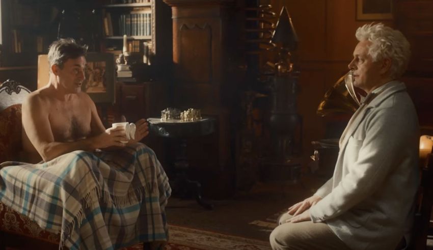Two men sitting in a room talking to each other.