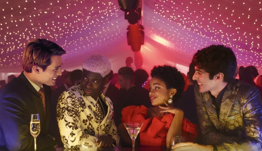 A group of people sitting around a table at a party.