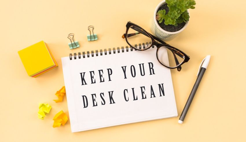 A notepad with the words keep your desk clean on it.