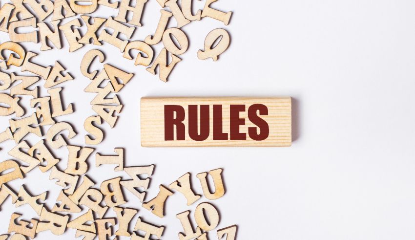 A wooden sign with the word rules surrounded by wooden letters.