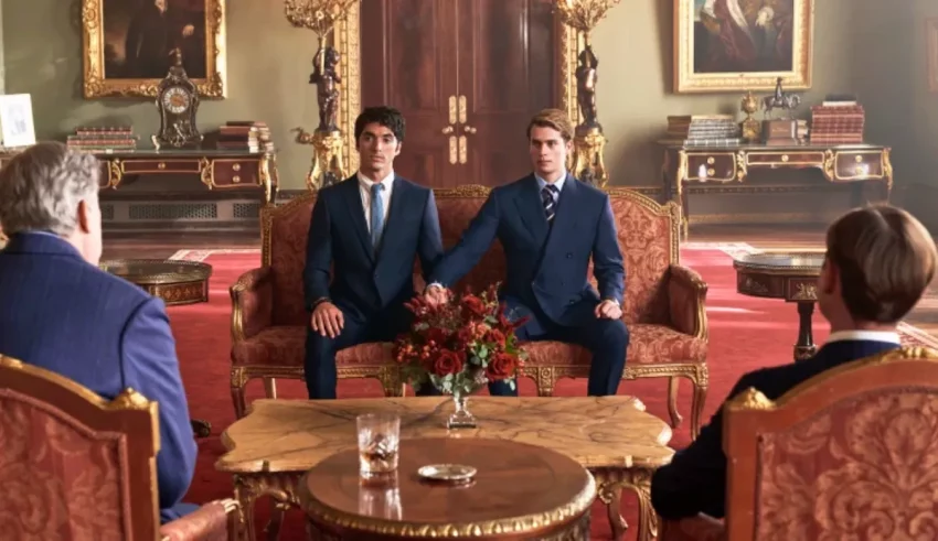 Two men in suits sitting in an ornate room.