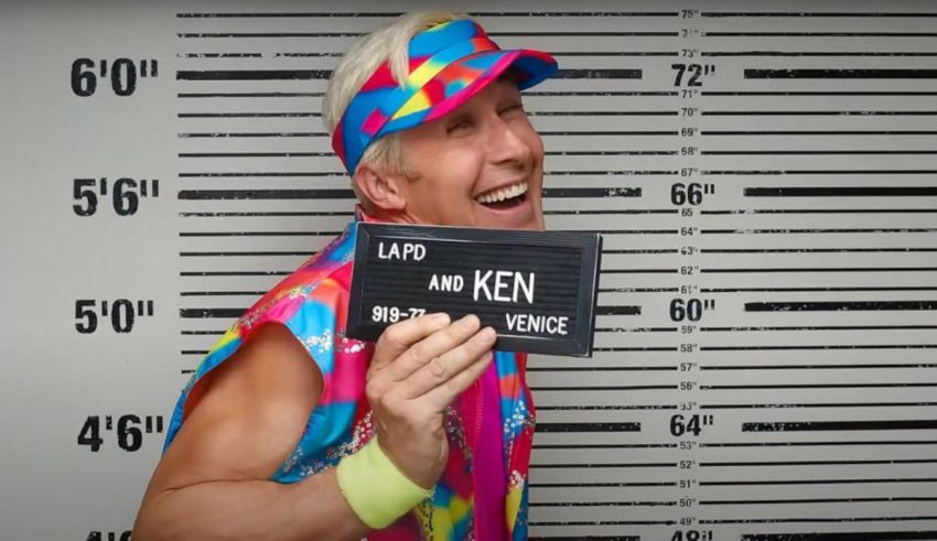 A man in a colorful outfit holding up a mugshot.