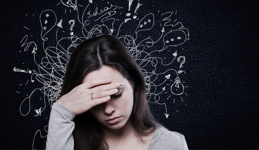 A woman holding her hand over her face with doodles on it.