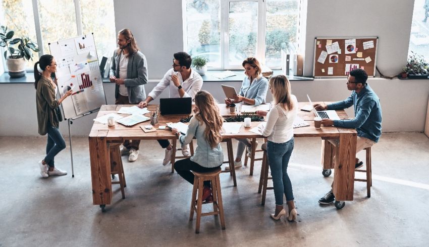 A group of people sitting around a table in an office.