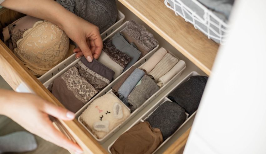 A woman is putting clothes into a drawer.