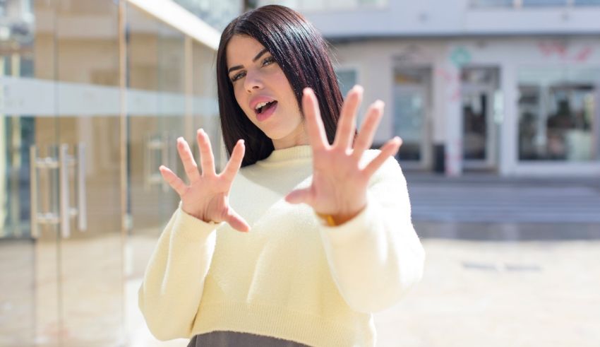 A woman is making a gesture with her hands.