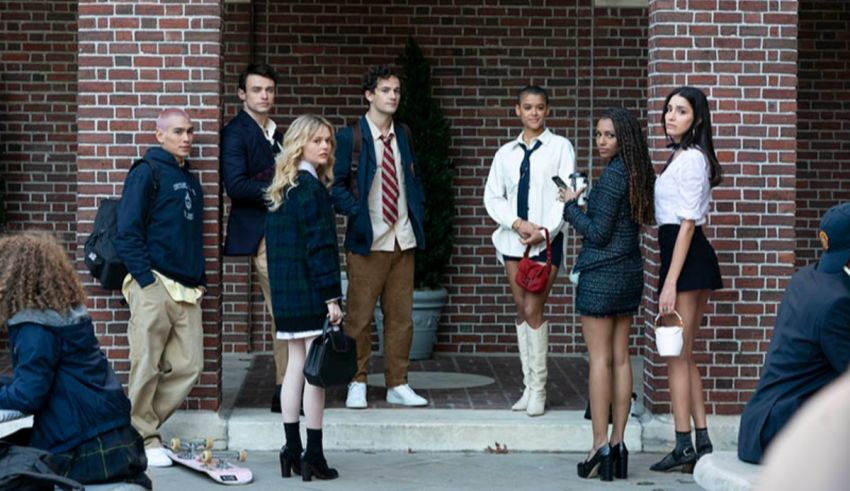 A group of people standing in front of a brick building.