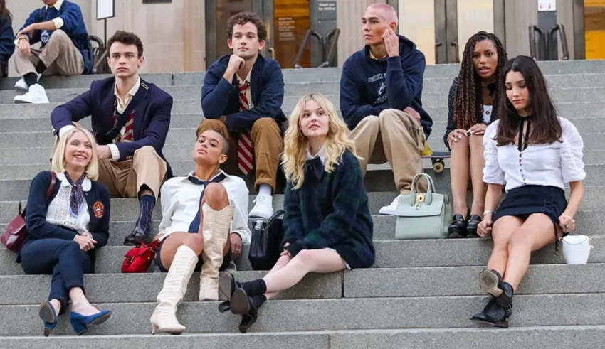 A group of young people sitting on steps in front of a building.