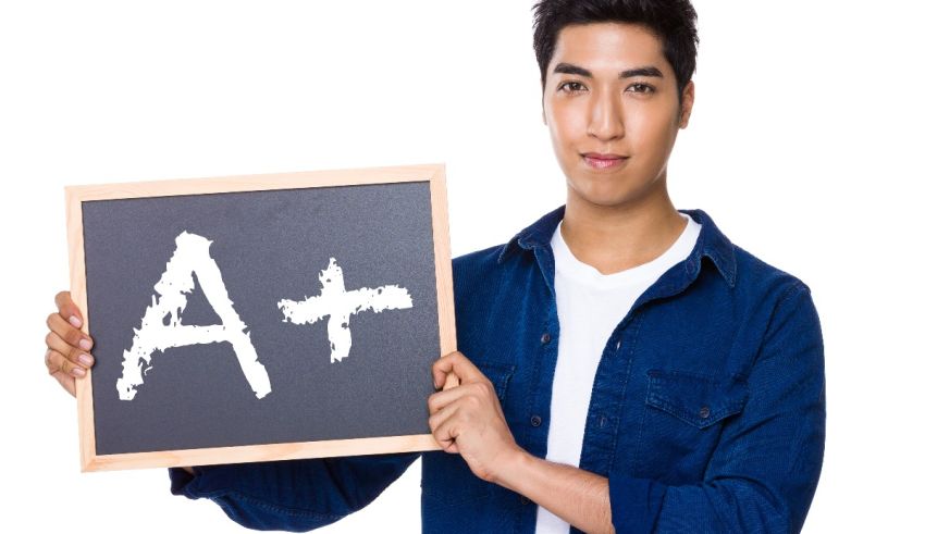 A man holding up a blackboard with the word a.