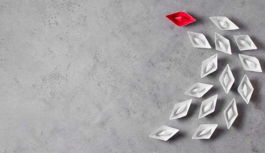 A group of white paper diamonds on a gray background.