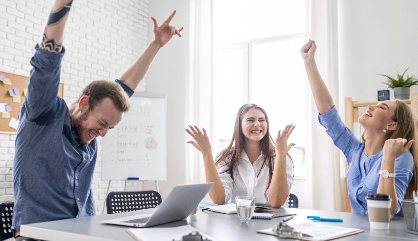 A group of people celebrating in an office.