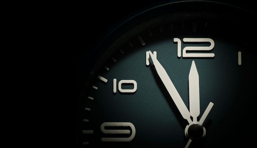 A clock with a white face on a black background.