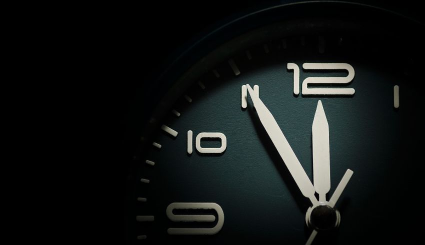 A clock with a white face on a black background.