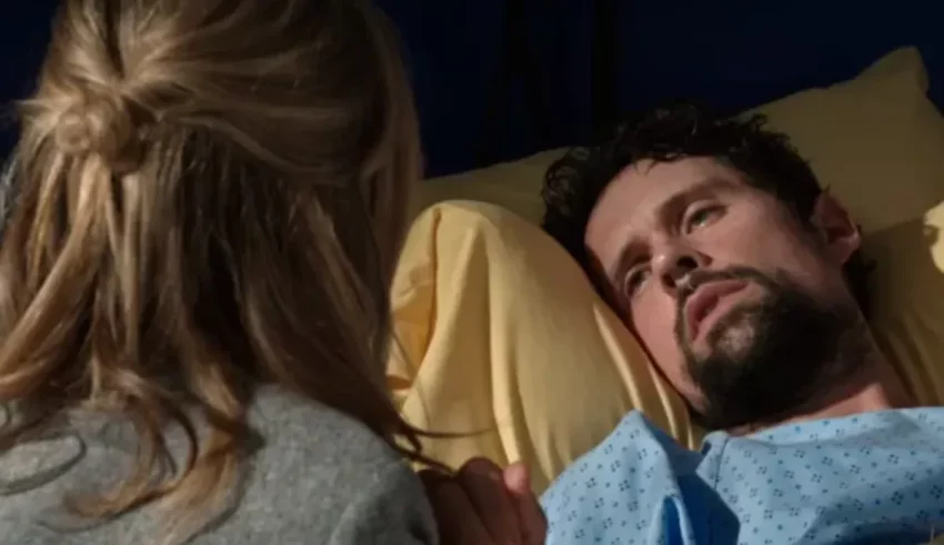 A man in a hospital bed looking at a woman.