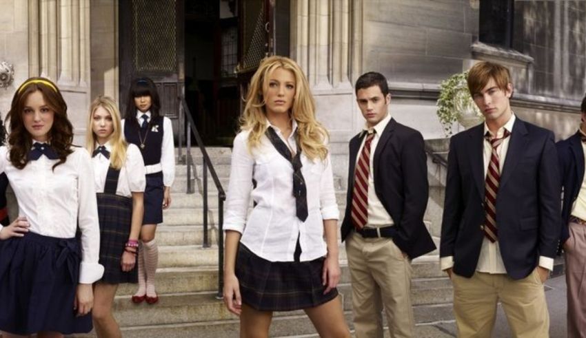 A group of people in school uniforms posing for a picture.