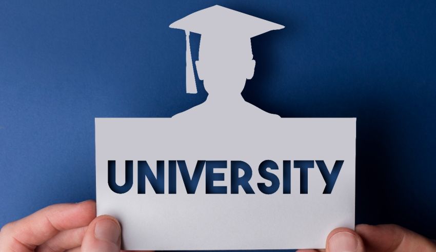 A person holding up a paper with the word university on it.