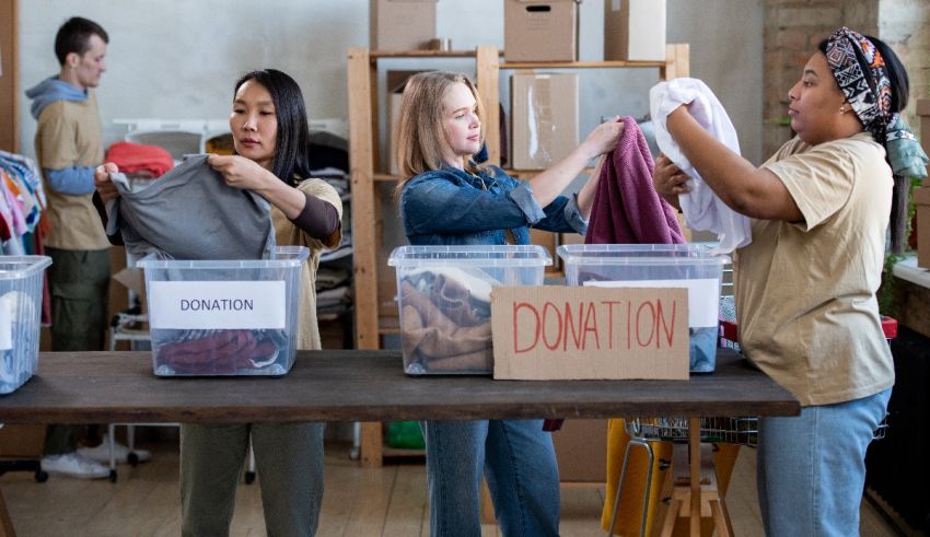 A group of people sorting clothes in a donation room.