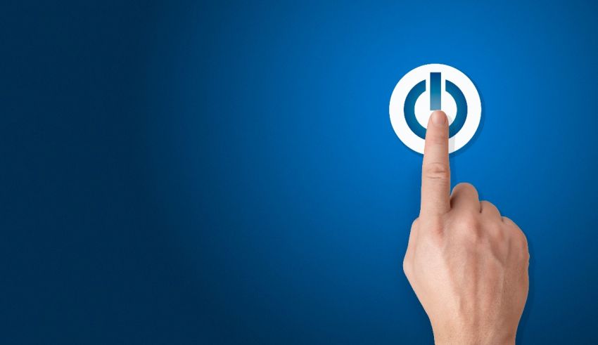 A hand is pointing at a power button on a blue background.