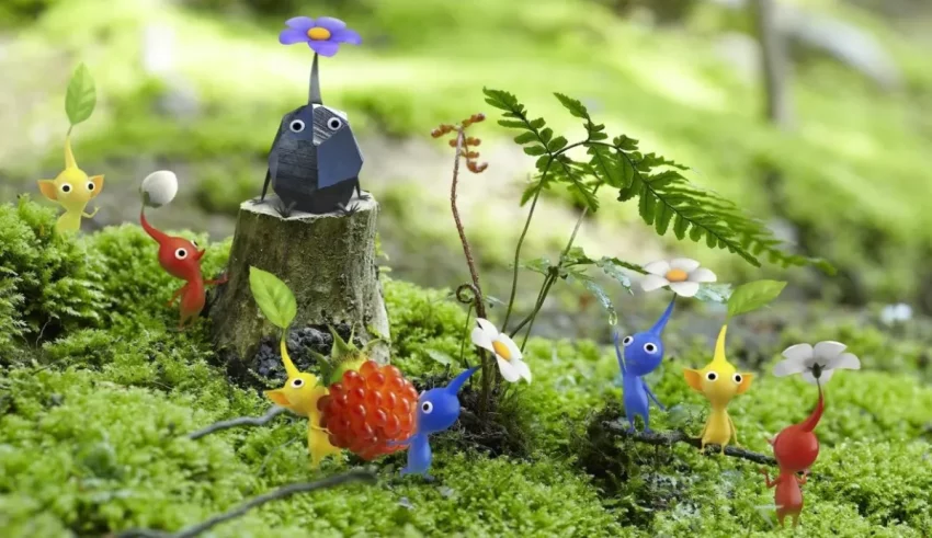 A group of small figurines in a mossy forest.