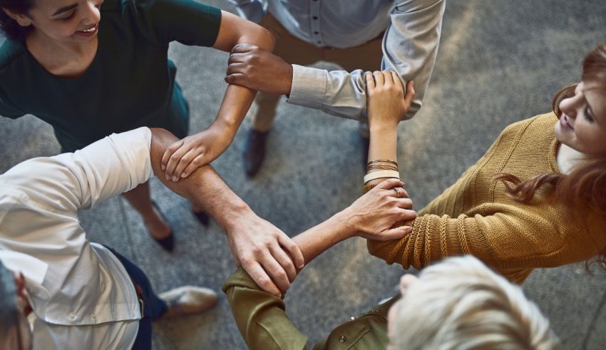 A group of people holding hands in a circle.