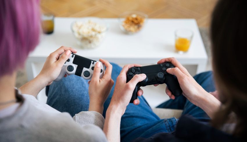 Two people playing video games on a couch.